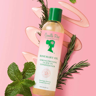 camille rose leave-in Conditioner bottle with rosemary oil on a pink background