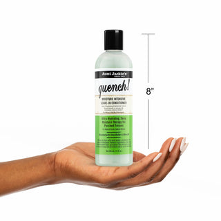 Bottle of Aunt Jackie's Quench leave-in conditioner held in a hand with a measurement label on a white background