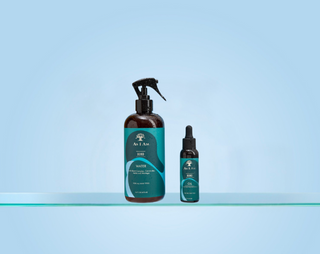 Two bottles of a haircare product on a light blue background