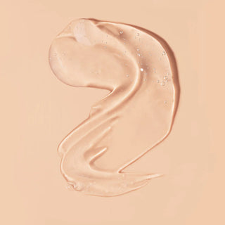 Close-up of a smooth, beige-colored skincare product on a matching background