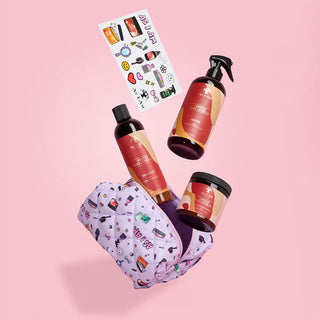 Cosmetic set with bottles and a pouch on a pink background