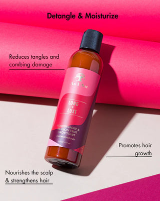 Bottle of hair care product with pink label on a pink background