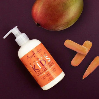 Bottle of Kids' Extra Nourishing Conditioner with an apple and carrots on a purple background