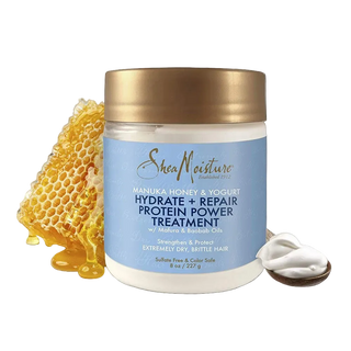 Shea Moisture hair treatment jar with honeycomb and yogurt on a white background