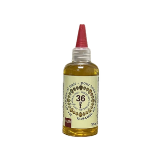 Bottle of hair oil with a red cap on a white background