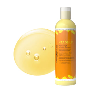 Shampoo bottle labeled 'HEADS UP' with a yellow circular object on a white background