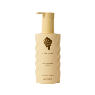 Beige bottle of Bounce Curl styling cream on a white background