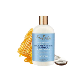 SheaMoisture shampoo bottle with honeycomb and shea butter on a white background