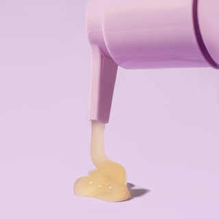 Purple container pouring a yellow substance onto a light purple background