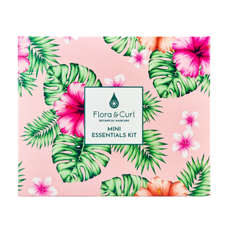Flora & Curl mini essentials kit with tropical leaf and flower design on a pink background