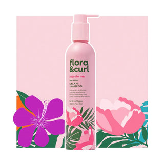 Flora & Curl shampoo bottle with floral design on a pink background