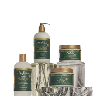 Set of hair care products with green and gold labels on a white background